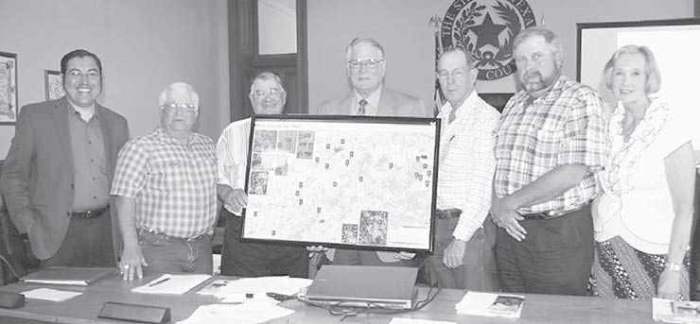 Framed maps of El Camino Real Trail presented to Milam County Commissioners.