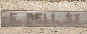 E. Bella St curb-level street sign
