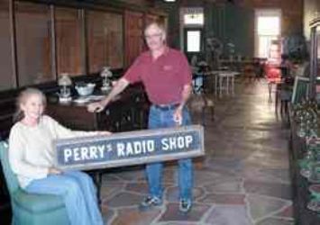Bernie & Kim Finley with original Perry Radio Shop sign